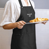 Black embroidered apron in use